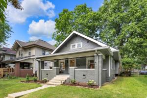 a home with a gray house at MidTown Cozy Cottage in Indianapolis