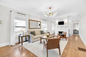 a living room with a couch and a table at MidTown Cozy Cottage in Indianapolis