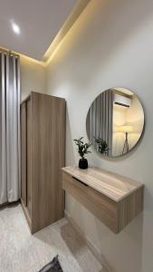 a bathroom with a mirror on the wall and a sink at Rest home in Tabuk