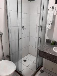 a bathroom with a shower with a toilet and a sink at Hotel Serra Sol in Serrinha +12 photos