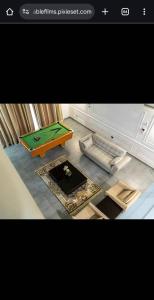a picture of a living room with a table and a pool at Emerald harbor apartments in Lekki