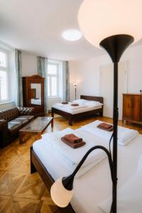 a living room with two beds and a couch at Cuba Bar & Hostel in České Budějovice