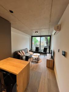 a living room with a couch and a table at Link in Montevideo