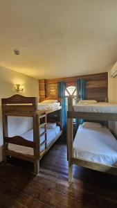 a room with three bunk beds in it at Hostal Blue Olas in Carenero