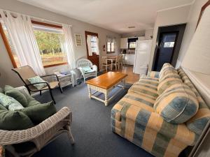 a living room with a couch and chairs and a table at Brookhaven 5 in Maple City
