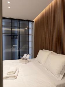 a bedroom with a bed with two towels on it at Chic Apartament Free Parking in Vlorë