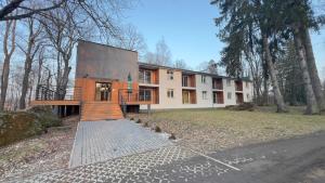 a house with a staircase in front of it at Apartamenty Dąbrówka Beauty - w parku leśnym , sauna in Jelenia Góra