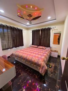 a bedroom with a bed and a ceiling at BFMS Villa, Royal Purandar in Purandhar