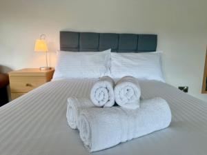 two towels are sitting on a bed at Retreat In The Hills, 1 Bedroom - Malvern in Mathon