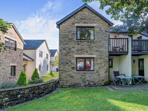a stone house with a stone wall at 3 Bed in Ullswater 85896 in Penruddock