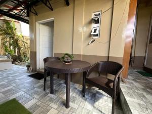 a small table and chairs in a room with aperature at Rustic Retreat Three Bedroom House in Pagdalagan