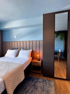 a bedroom with a bed and a lamp on a table at LIV apto 1211 - Loft novo com vista in Porto Alegre