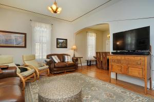 a living room with a large flat screen tv at The Caddis Cottage in Salida