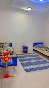 a room with two beds and a table in it at Apartment ready for daily rent Quiet, two bedrooms in Al Madinah