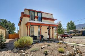 a small house with blue shutters on a street at The Caddis Cottage in Salida