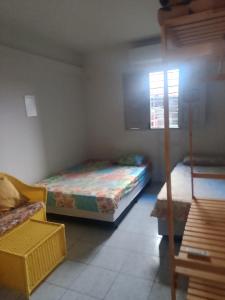 ein kleines Zimmer mit zwei Betten und einem Fenster in der Unterkunft Hostel da Josi - Porto de Galinhas in Porto De Galinhas