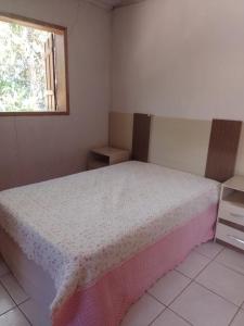 a bedroom with a bed and a window at Sitio Recanto das águas in São João del Rei