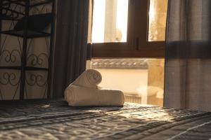 a towel sitting on top of a bed with a window at Cal Massana in Sant Guim de la Plana
