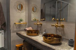 a bathroom with two wooden sinks on a counter at Cal Massana in Sant Guim de la Plana