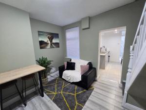 a living room with a chair and a stair case at Room 2 Shared house 5 min from Sefton Park in Liverpool