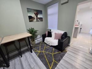 a living room with a chair and a table at Room 2 Shared house 5 min from Sefton Park in Liverpool