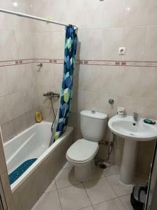 a bathroom with a toilet and a sink at 5 minutes from the beach in Mindelo
