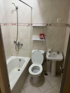 a small bathroom with a toilet and a sink at 5 minutes from the beach in Mindelo +1 photo