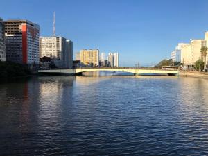 a bridge over a river in a city with buildings at Casa Ariano in Recife +32 photos