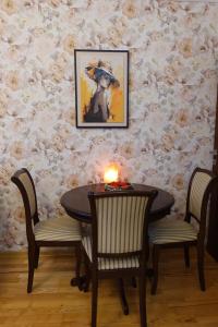 a table with two chairs and a candle on it at Tatra Apartment Palace Hill with angels and sauna in Poprad