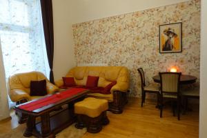 a living room with a couch and a table at Tatra Apartment Palace Hill with angels and sauna in Poprad