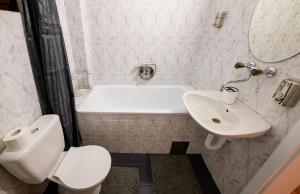 a bathroom with a white toilet and a sink at Sunset in Kriva Palanka +59 photos