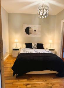 a bedroom with a large bed and two lamps at La Pause Montréal in Montreal