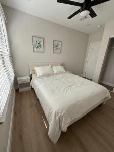 a bedroom with a large bed with a ceiling fan at Casa Nova St Augustine close to Beaches, Downtown, Pier in St. Augustine