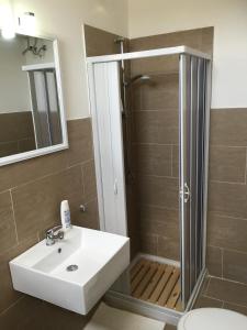 a bathroom with a shower and a sink and a toilet at B&B Del Popolo in Torre Chianca