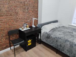 ニューヨークにあるAycee 417のレンガの壁、ベッドルーム1室(ベッド1台、デスク付)