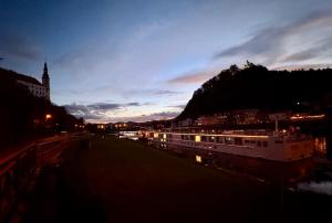 a view of a city at night with a river at Podzámčí - útulný byt na nábřeží pod zámkem in Děčín +23 photos
