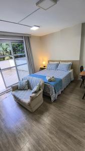 a large bedroom with a bed and a couch at Saint Sebastian 106 in Jaraguá do Sul