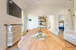 a large wooden table in a living room with a couch at Lakefront apartment with terrace near Como in Montorfano