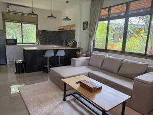 a living room with a couch and a table at Zout Villas in Thong Sala +226 photos