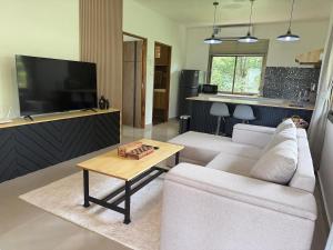 a living room with a white couch and a table at Zout Villas in Thong Sala