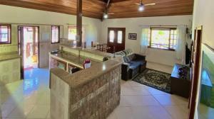 a large room with a kitchen and a living room at Suíte4 Pousada Arpoador a pé da Praia Búzios in Búzios