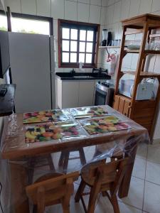 a kitchen with a table with fruit on it at Flat Beira Mar in Ilha Comprida +10 photos