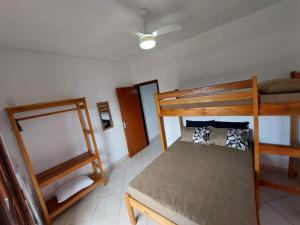 a bedroom with two bunk beds and a mirror at Flat Beira Mar in Ilha Comprida