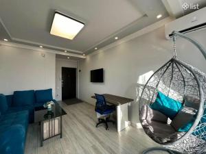 a living room with a blue couch and a swing at Apartment Zaqyan street in Yerevan +1 photo