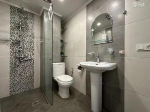 a bathroom with a toilet and a sink and a shower at Apartment Zaqyan street in Yerevan