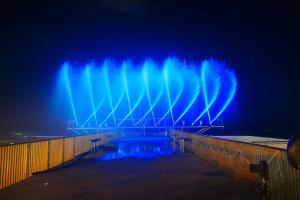 バト・ヤムにあるחדר על הים בבת יםの暗闇の中に青と緑の光が輝く噴水