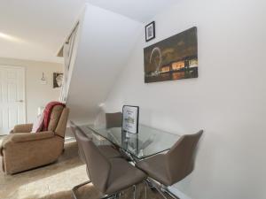 a dining room with a glass table and chairs at Top Lodge in Llanvair Discoed
