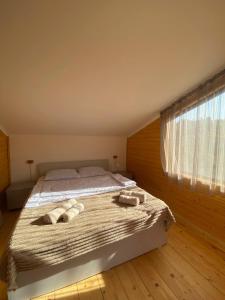 a bedroom with a bed with two towels on it at Forest Panorama House Dilijan in Dilijan