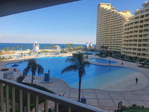 a view of a large swimming pool from a balcony at APARTMENT PORTO El SOKHNA EGYPT-FAMILY in Ain Sokhna