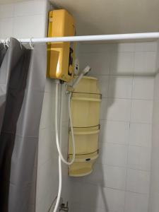 a bathroom with a yellow box on the wall at Ally home 14 06 in Thung Si Kan